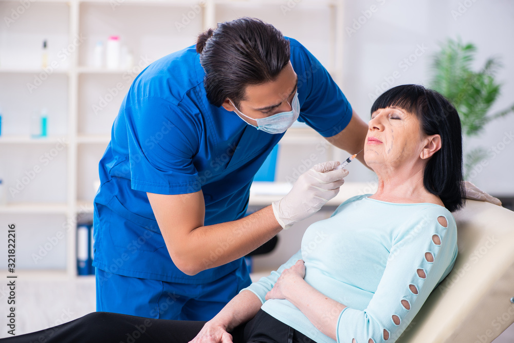 Old woman visiting male doctor for plastic surgery Old woman visiting male doctor for plastic surgery
