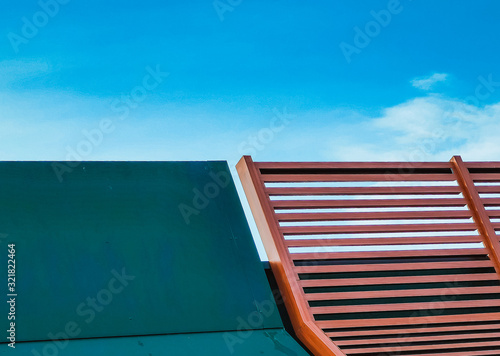 Wooden sun lounger at the beach or on a cruise ship against sunny blue sky © nbnserge