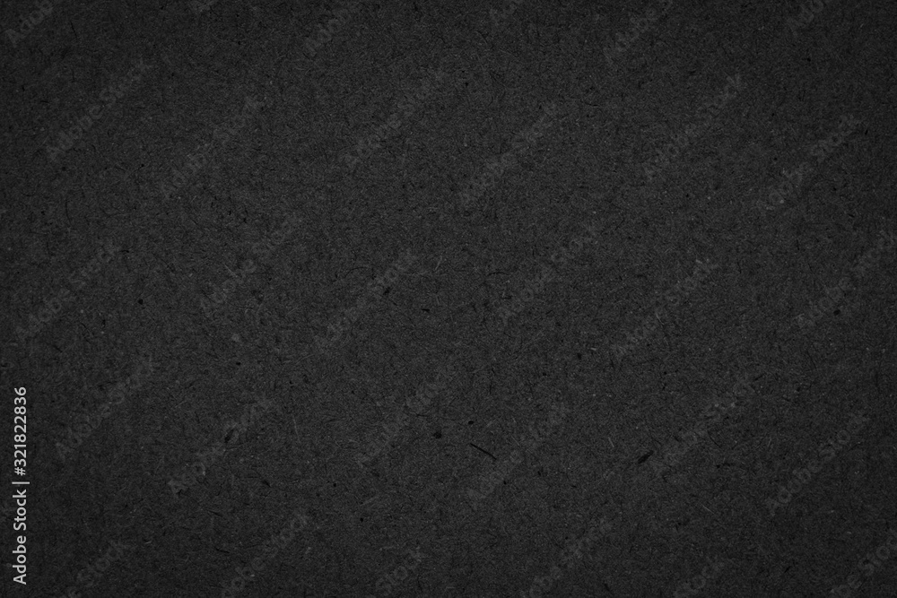 Fototapeta premium Texture of black gift rough paper with fibers. Dark background for design, template, greeting card, website backdrop.