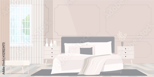 Cozy beige colored blanket on king size bed in bright bedroom