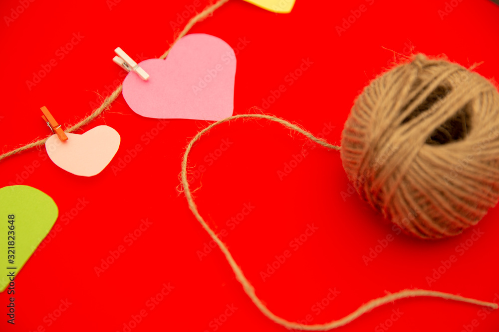 Hearts cut out of paper on a clothespin, Happy valentines day. red color Background Hearts cut out of paper on a clothespin, Happy valentines day. red color Background