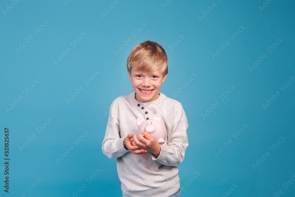 children's pocket money. Little boy with piggy Bank children's pocket money. Little boy with piggy Bank