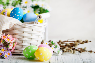 Happy Easter. Congratulatory easter background. Easter eggs and flowers. Background with copy space. Selective focus.