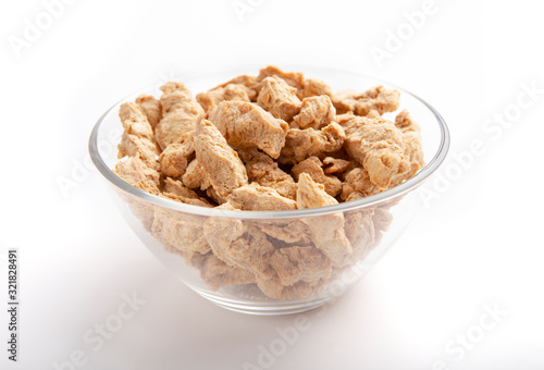 Trendy soy meat in glass bowl on white background