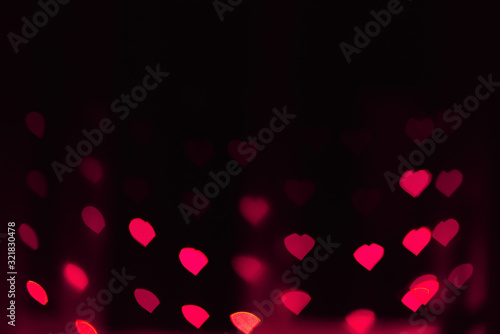 Abstract blur defocused background black, pink lights highlights, bokeh hearts, soft focus