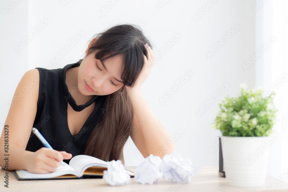 Beautiful asian woman tired and stressed with writing overworked at desk, girl with worried not idea with notebook and crumpled paper at office, freelance and business concept. Beautiful asian woman tired and stressed with writing overworked at desk, girl with worried not idea with notebook and crumpled paper at office, freelance and business concept.