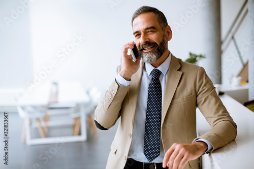 Senior businessman using mo...