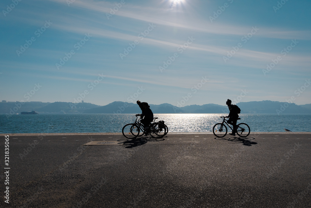 Fototapeta premium Walking along the banks of the Tagus River on a bicycle. The area of Lisbon is Belem. Portugal.