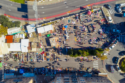 Flea Market in an Old city street with People and Colourful goods on display, Top down aerial view. © STOCKSTUDIO