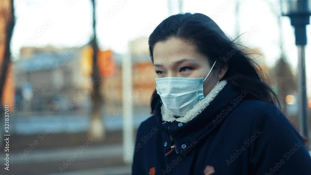 Portrait of an Asian girl, a Chinese woman in a mask to protect against smog and viruses. Portrait of an Asian girl, a Chinese woman in a mask to protect against smog and viruses.