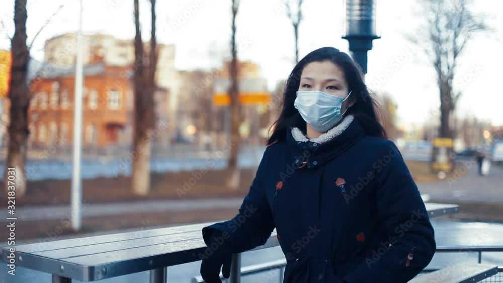 Portrait of an Asian girl, a Chinese woman in a mask to protect against smog and viruses. Portrait of an Asian girl, a Chinese woman in a mask to protect against smog and viruses.