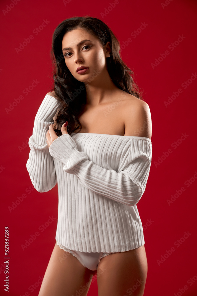 Brunette model posing in sweater.