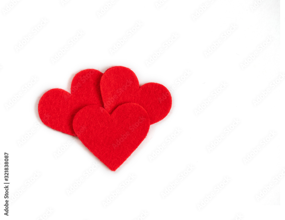 Red textile hearts on a white background. Valentines day concept. Copy space, top view.