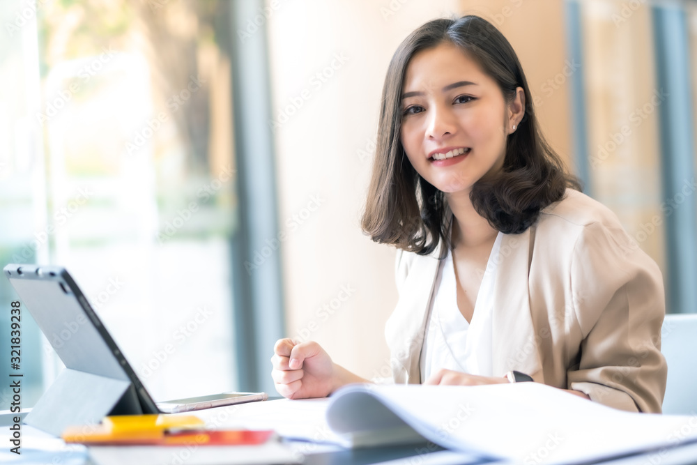 Architect or interior designer working with material sample board in showroom. Business of Real estate, home decoration .Creative people workplace.  young designer woman working  at office desk.