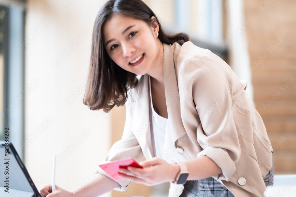 Architect or interior designer working with material sample board in showroom. Business of Real estate, home decoration .Creative people workplace.  young designer woman working  at office desk.