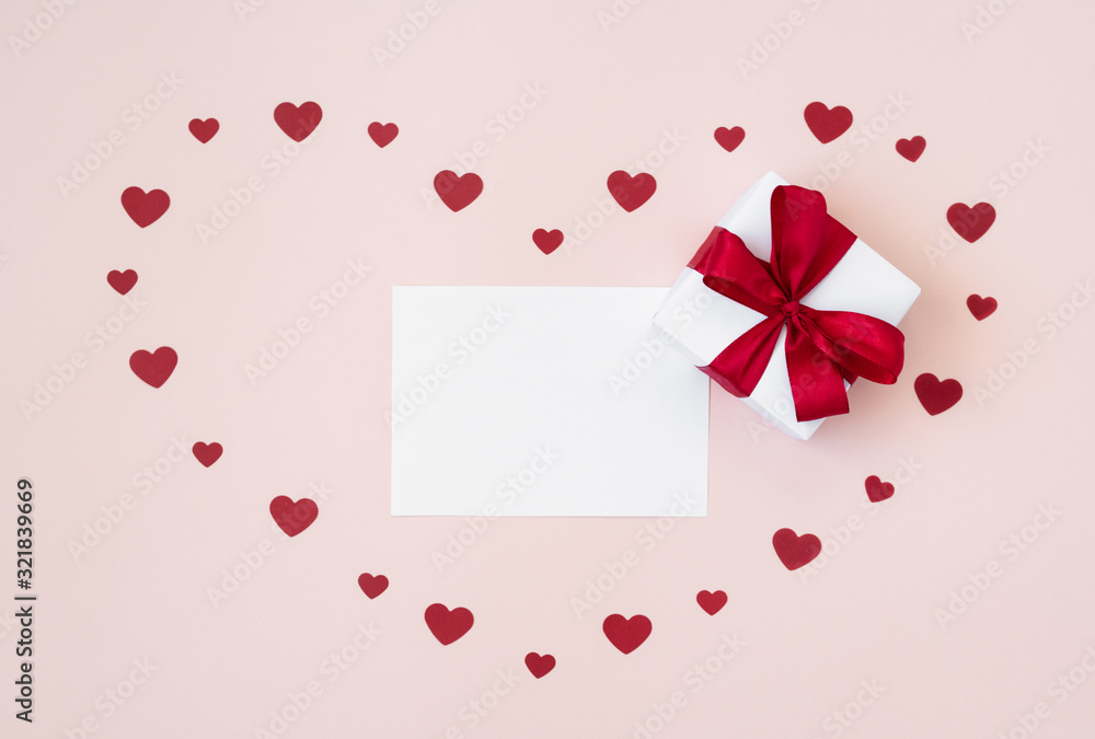 Valentines day mockup. Greeting card with a gift and confetti hearts on a pastel pink background. Valentines day concept.
