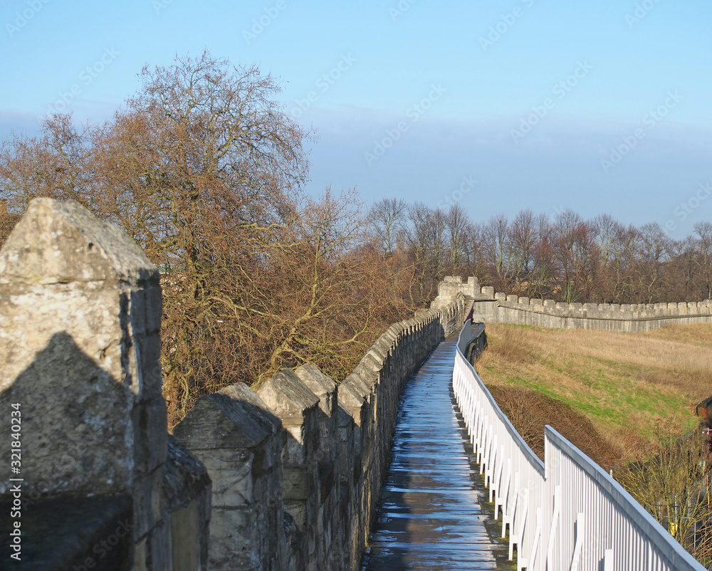 Fototapeta premium a view along the pedestrian walkway on historic medieval city walls in york