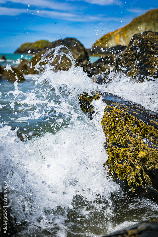 Water splashing against rock on a secluded beach