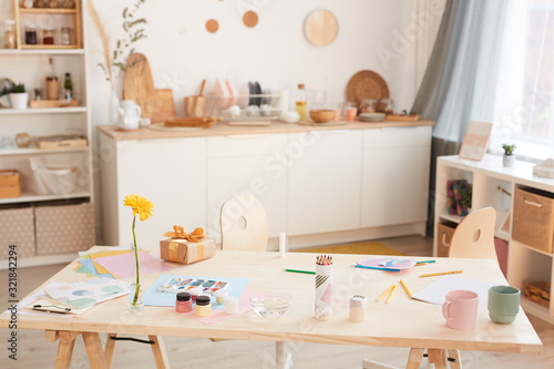 Fotografie Warm-toned background image of cozy kitchen interior with wooden table in foregr
