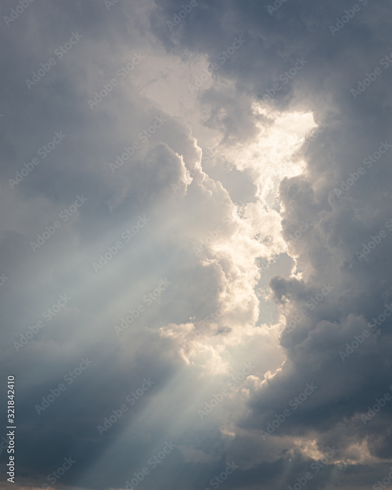 Obraz premium Sunbeam between storm clouds cloudscape sky