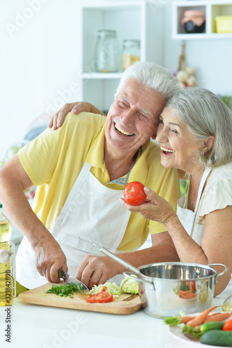 Close up portrait of senior couple cooking