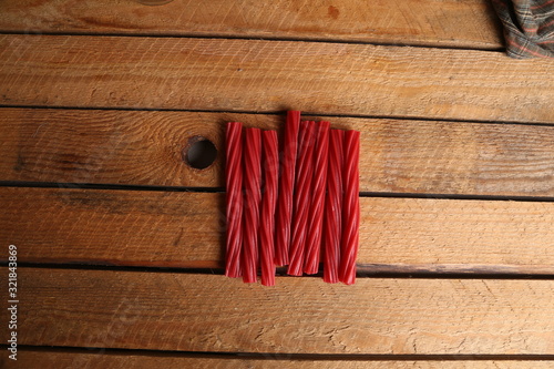 sweet red gummy licorice in color background photo