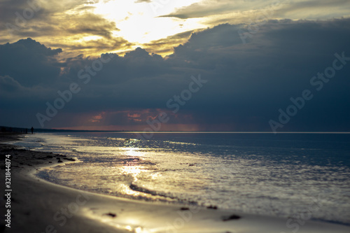 Sea ocean landscape at sunset with volumetric light (god rays) Baltic shore coast at dusk