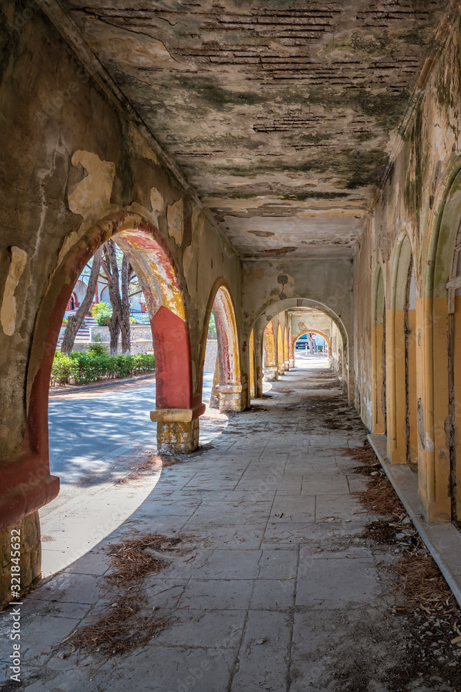 Fototapeta premium Column corridor of deserted building of sanatorium in Italian village of Eleousa (Rhodes, Greece)