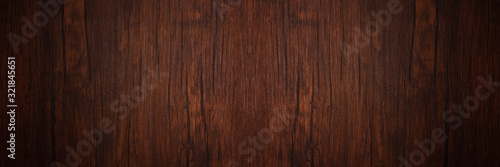 Seamless dark brown wooden board texture background with vignette