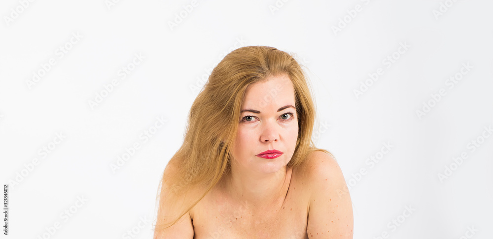 Fototapeta premium Beautiful and stylish 40 year old woman. Face portrait on white background