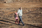 Father teaches little daughter to walk on a sling, slackline