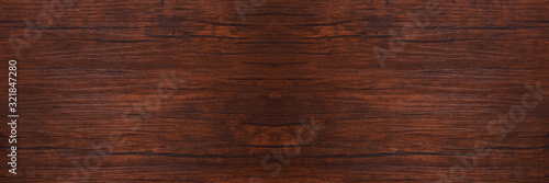 Seamless dark brown wooden board texture background with vignette