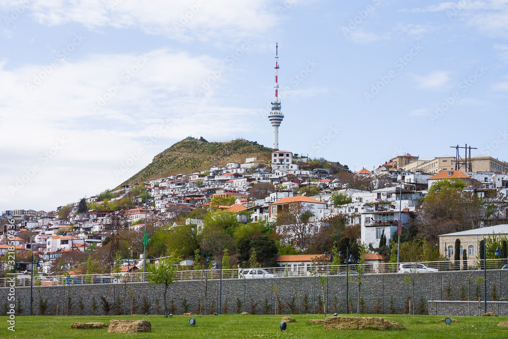 Obraz premium Panorama of the city of Baku, the capital of the Republic of Azerbaijan. Old houses built on a mountain on the outskirts of the city. The houses are built up on the hill in form of terraces.