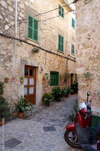 Picturescue street of Valldemossa with red scooter. Majorca  Spain