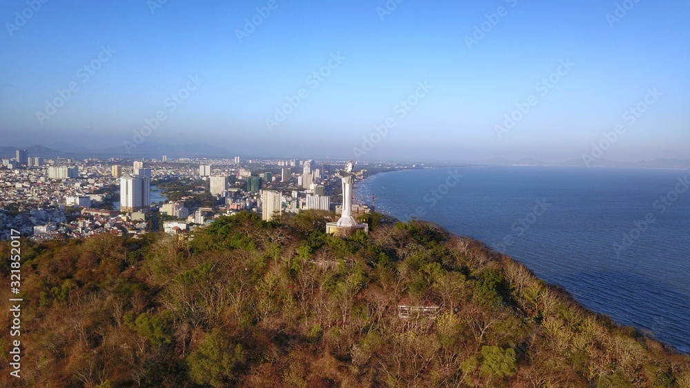 Drone view of Christ the King, a statue of Jesus, standing on Mount Nho in Vung Tau city, Ba Ria Vung Tau province, near Ho Chi Minh city, Vietnam.