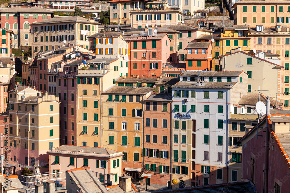 Group of palaces facades of Camogli, painted with famous pastel colors. Camogli is a small fisherman village on the shores of the Ligurian Sea. (Northern Italy).