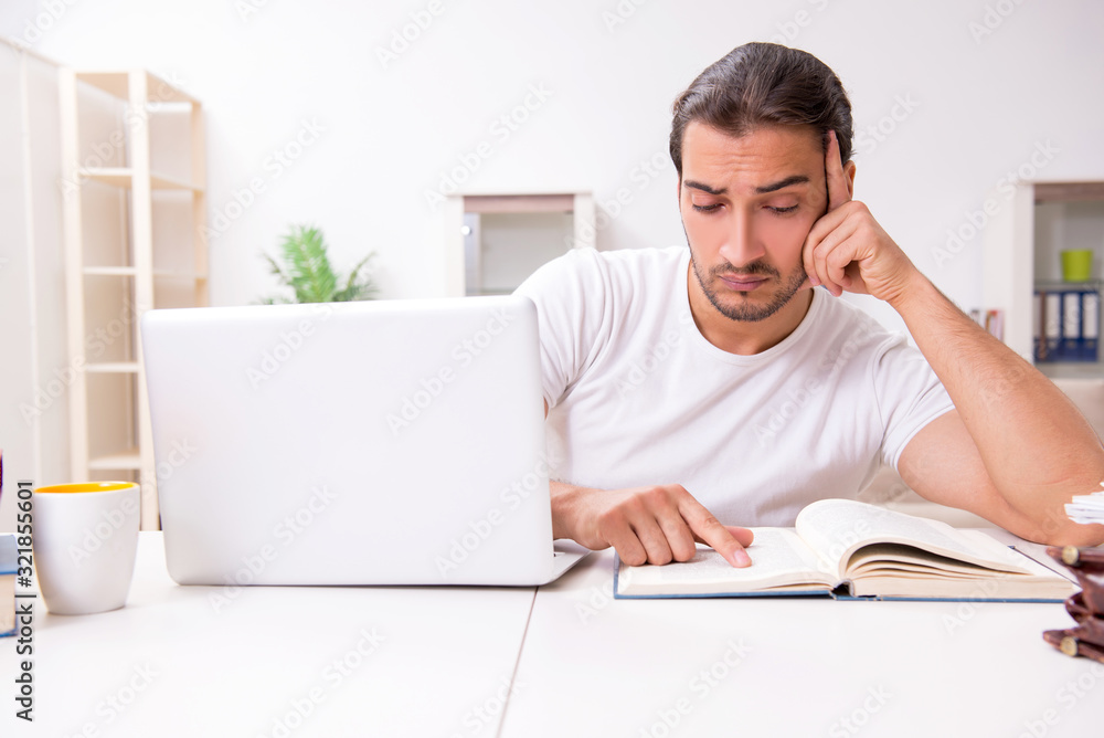 Young male student preparing for exams at home Young male student preparing for exams at home