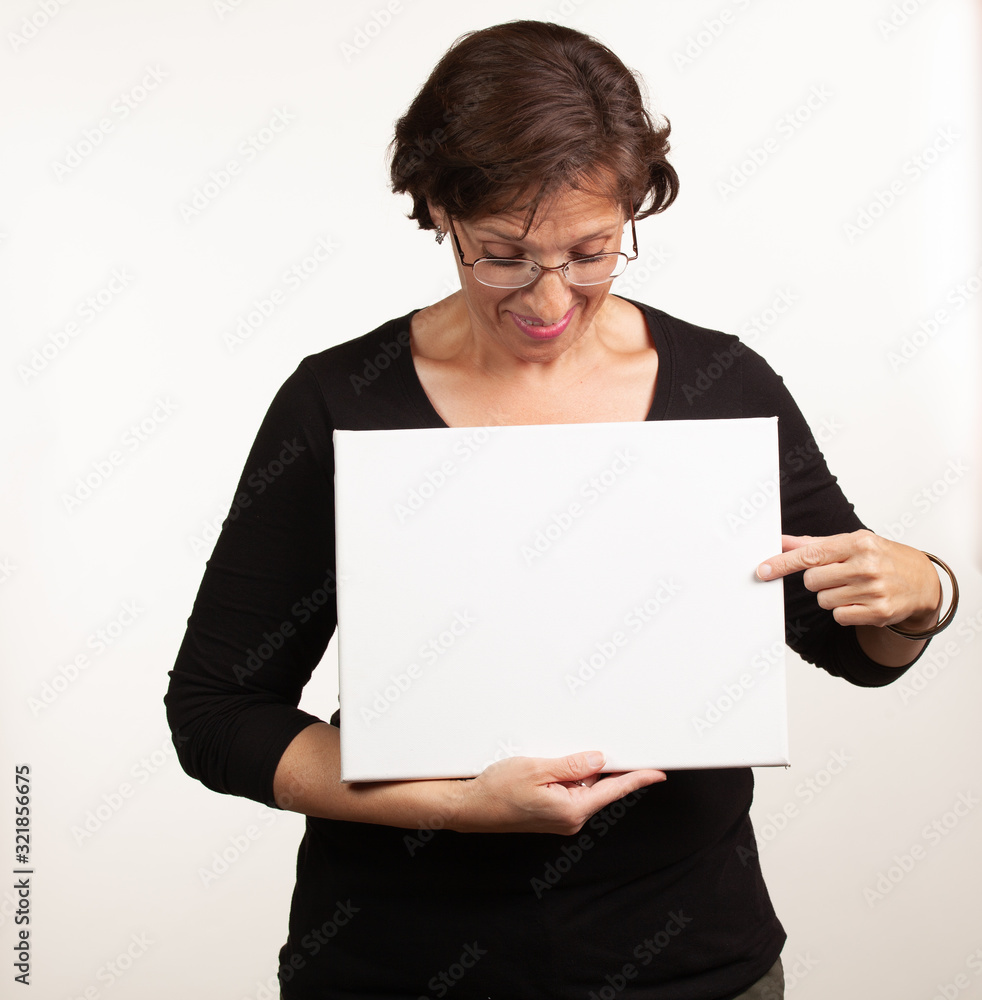 Woman holding up a blank white sign with room for your copy Woman holding up a blank white sign with room for your copy