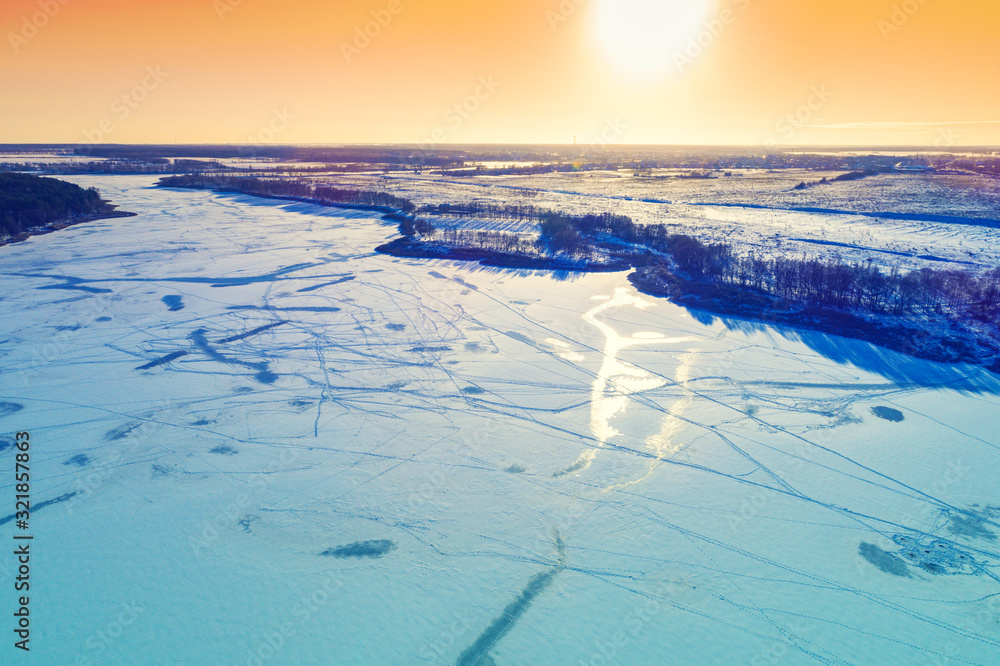 Aerial view of the frozen lake in winter at sunset Aerial view of the frozen lake in winter at sunset