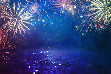 abstract gold, black and blue glitter background with fireworks. christmas eve, 4th of july holiday concept