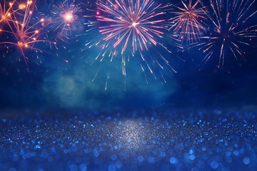 abstract gold, black and blue glitter background with fireworks. christmas eve, 4th of july holiday concept