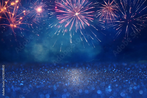 abstract gold, black and blue glitter background with fireworks. christmas eve, 4th of july holiday concept