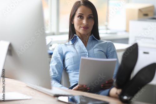 Confident female boss reads report in office. Psychology modern woman. Teacher checks completed tasks. Information for psychotherapists, consultants for women's crisis centers, actors and directors.