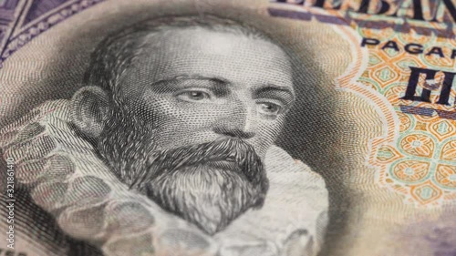 Wallpaper Mural Miguel de Cervantes portrait on Spain 100 pesetas banknote (1928) rotating. Famous Spanish writer. Low angle, macro. 4K, 422 10 bit Torontodigital.ca