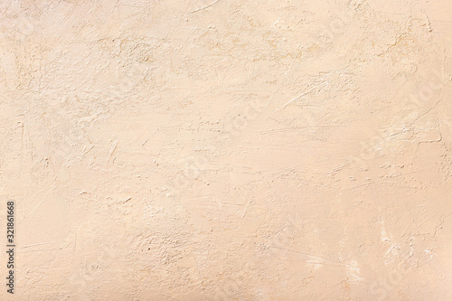 decorative plaster of neutral beige color. textured background. monochrome. selective focus.