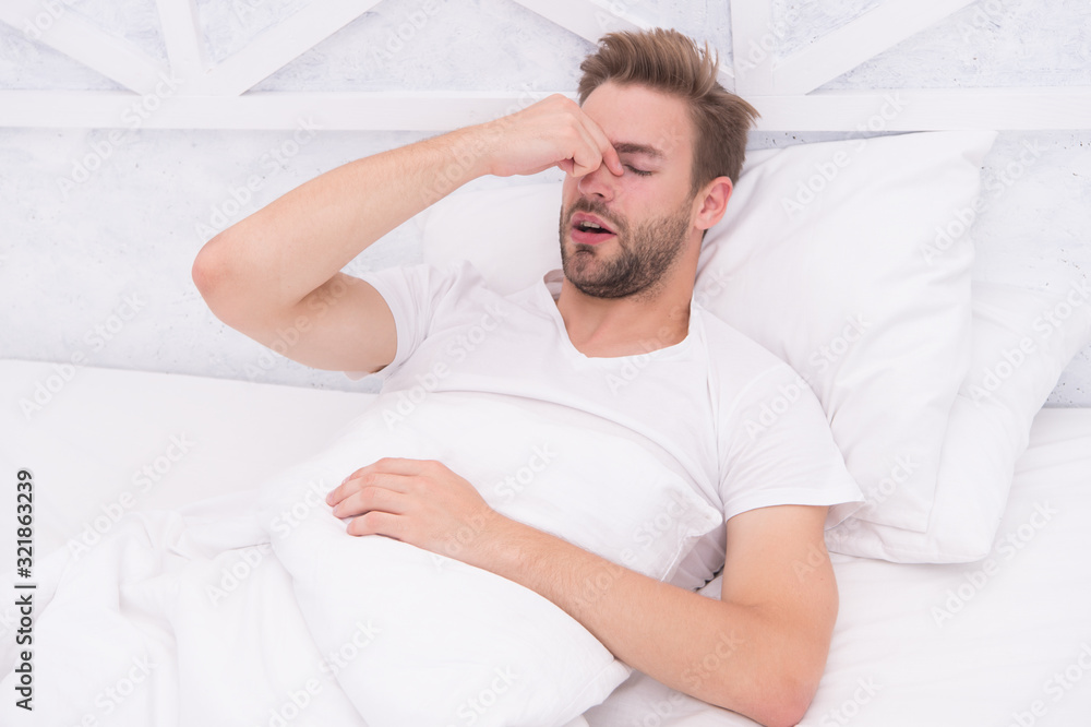 Snoring can increase risk headaches. Common symptom of sleep apnea. Causes of early morning headache. Migraine headaches. Sleep problems can lead to headaches in morning. Handsome man relaxing in bed Snoring can increase risk headaches. Common symptom of sleep apnea. Causes of early morning headache. Migraine headaches. Sleep problems can lead to headaches in morning. Handsome man relaxing in bed