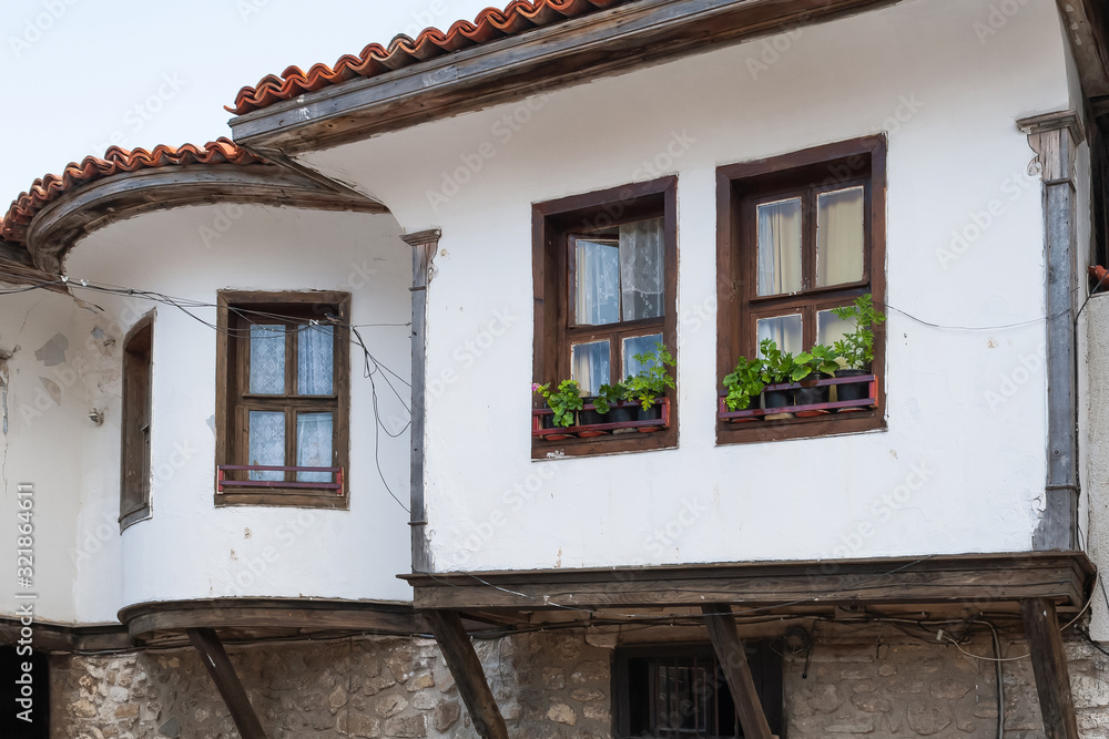 Old Town of Nesebar. Authentic cute facade of a Bulgarian house. ground floor made of stone