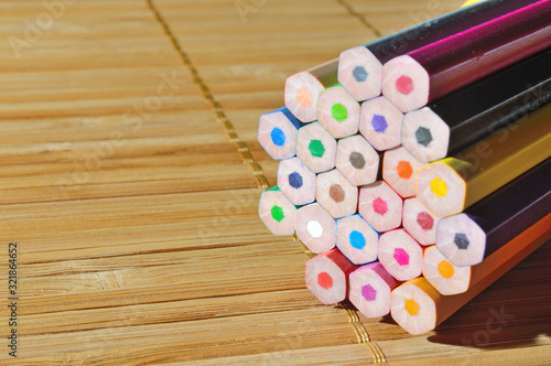 stack of pencils on wooden background