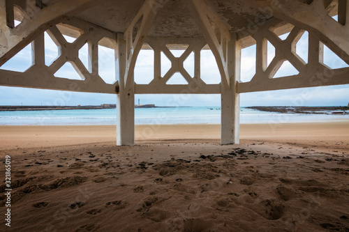 Hidden place in the beach. Picture taken from the lower part of a building. Quite place to contemplate the blue see. In Playa la Caleta, Cadiz, Spain.