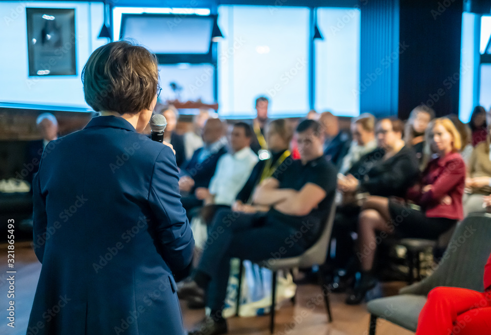 Fototapeta premium Female presenter speaks to audiences